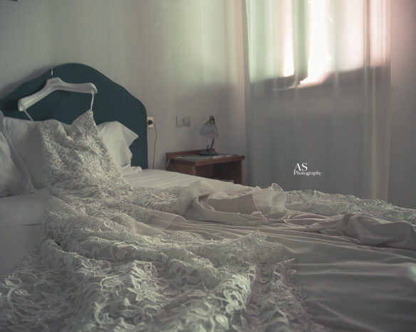 wedding dress on bed